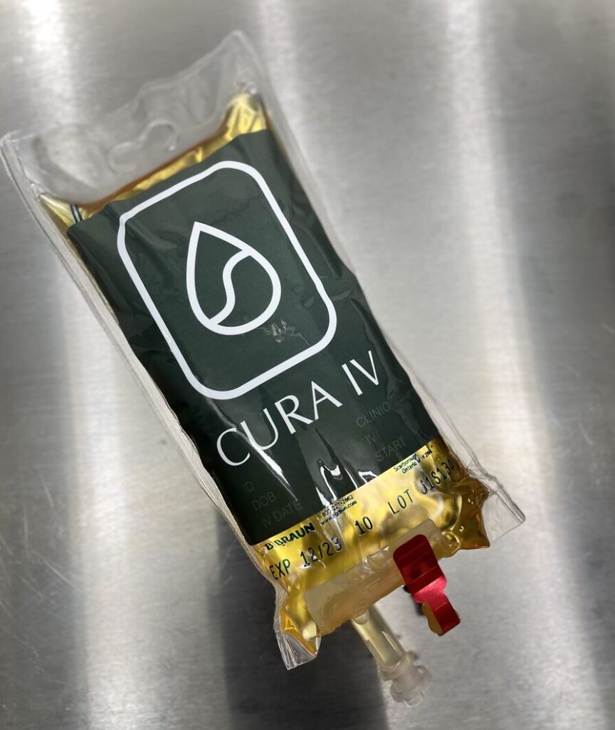 cura IV intravenous bag with yellow solution on stainless steel tabletop